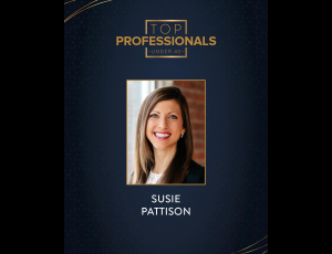 Blue background with Top Professionals Under 40 logo at the top, photo for woman with long brown hair and her name, Susie Pattison, under it.